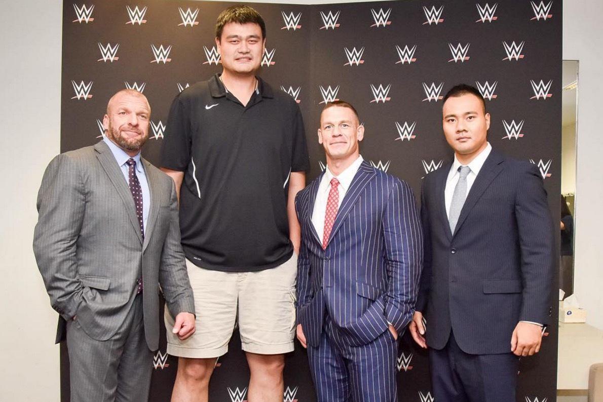 Giants of the Court: Wrestlers Standing Next to Basketball Players.